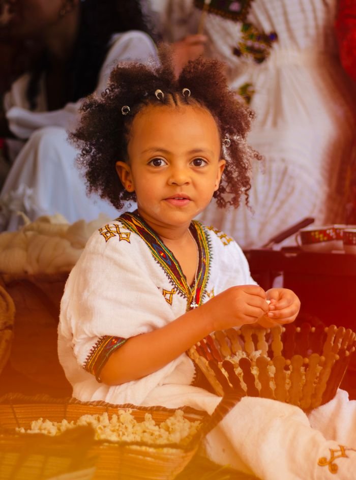 services-img A young girl in Ethiopian attire participates in a vibrant cultural festival.