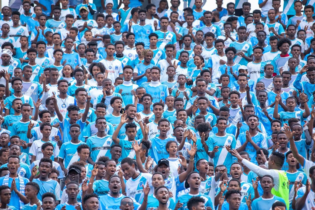 services-01 A vibrant crowd of soccer fans passionately cheering at a stadium in Bahir Dar, Ethiopia.