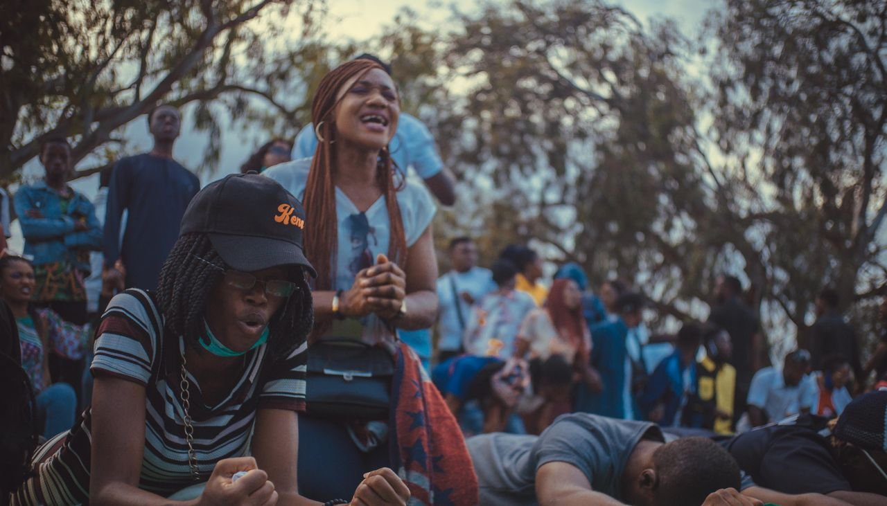 services-03 A vibrant and passionate scene of a diverse group of people protesting outdoors.